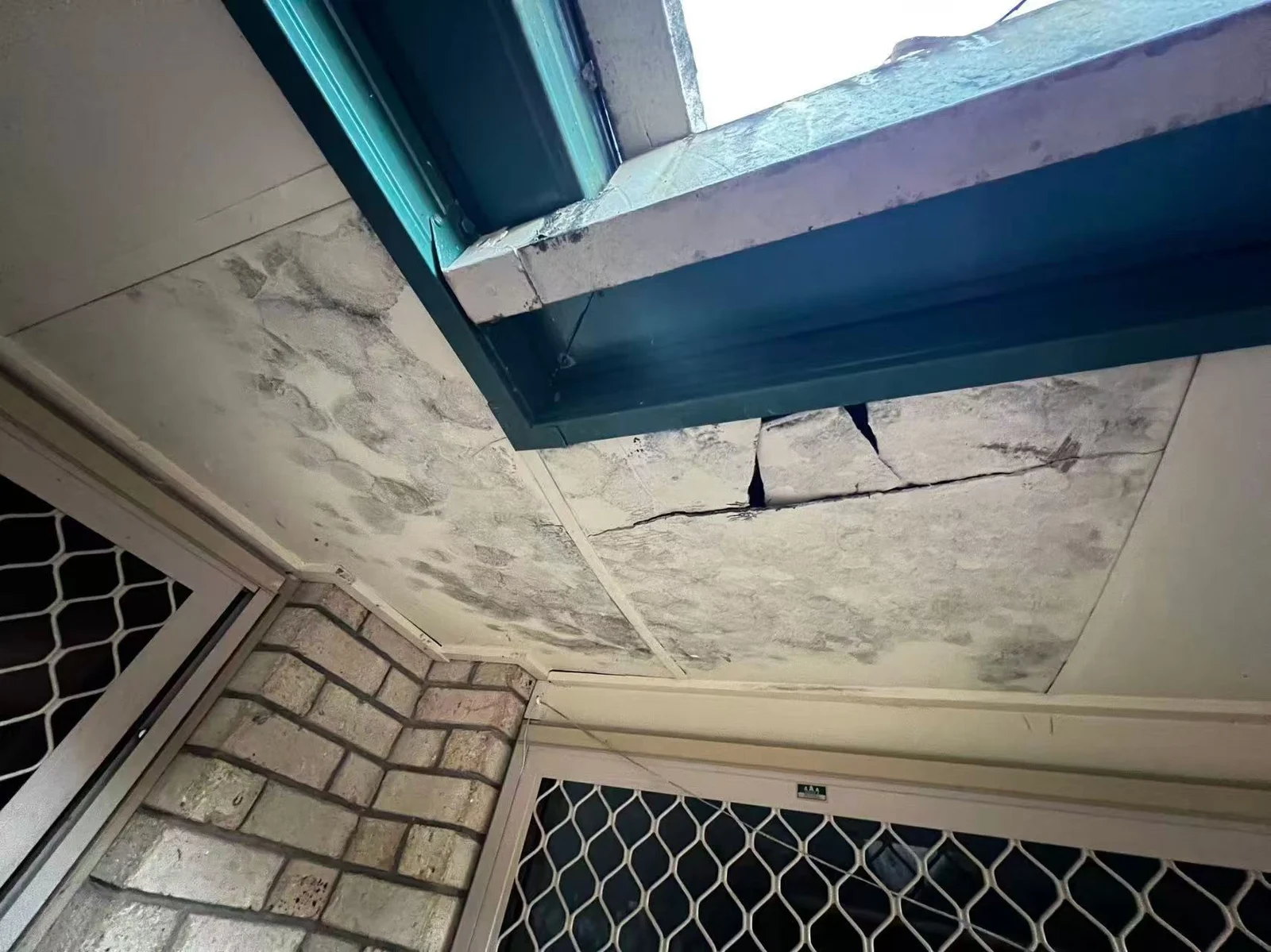 Damaged eaves lining beneath the roof edge before repair