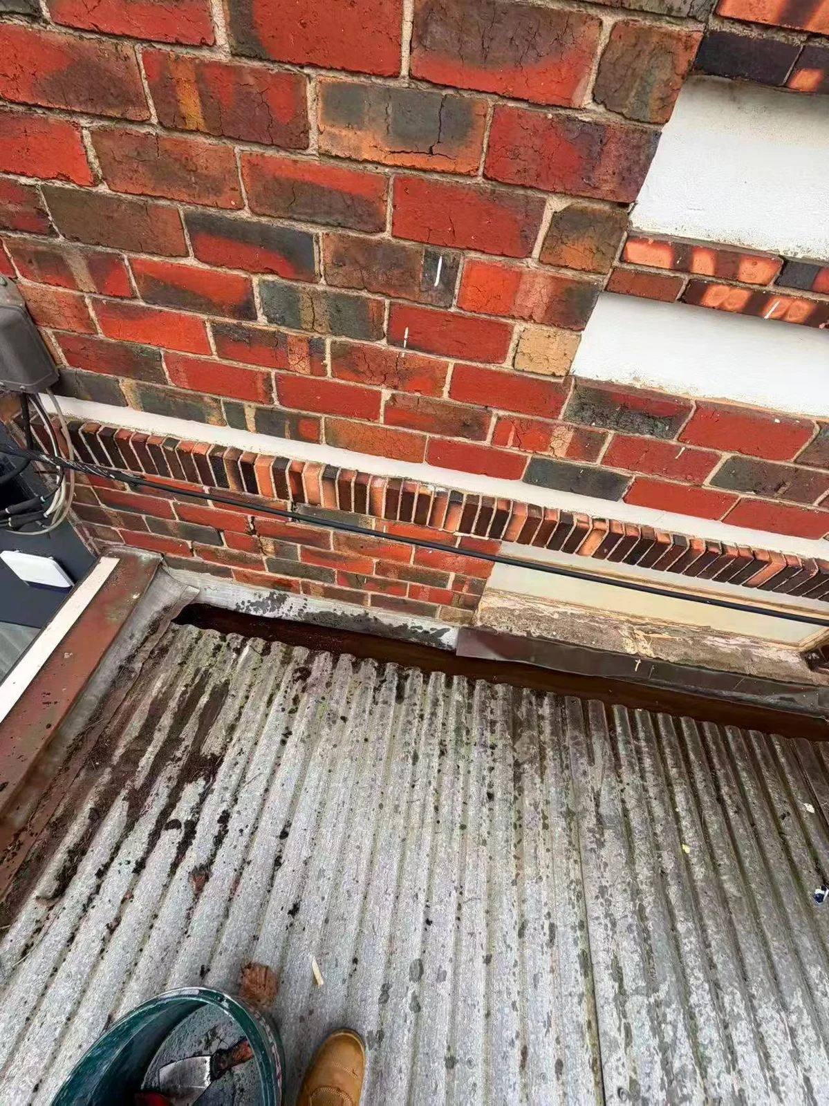 The wall-side gutter after cleaning, with some water visible